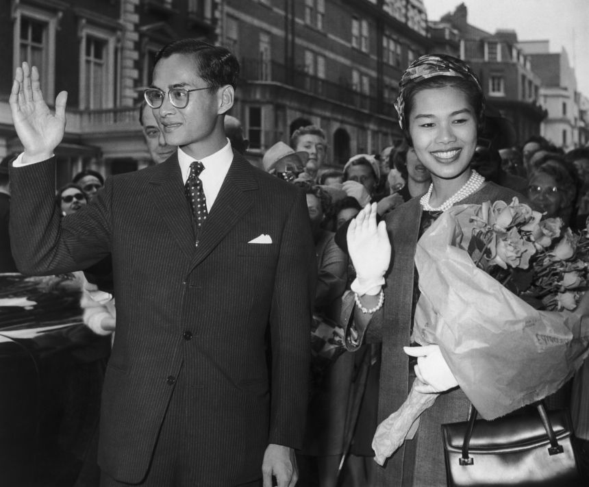 King Bhumibol and Queen Sirikit of Thailand wave to the crowds during a visit to Britain, 1960.