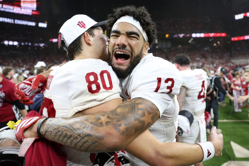 Indiana Hoosiers wide receiver Elijah Sarratt (No. 13) and wide receiver Charlie Becker (No. 80) celebrate after defeating the Ohio State Buckeyes in the 2025 Big Ten championship.